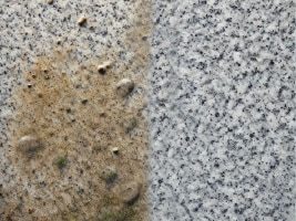 Natursteinfassaden Eine zur hälfte gereinigte Natursteinfassade